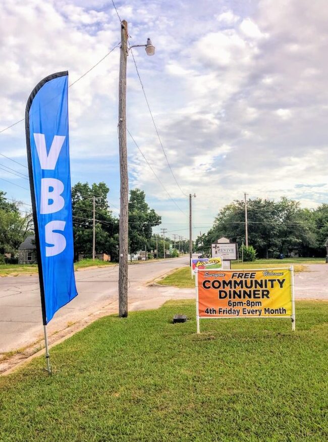 A banner that says VBS, and a sign that says "free community dinner 4th Friday every month 6-8pm"