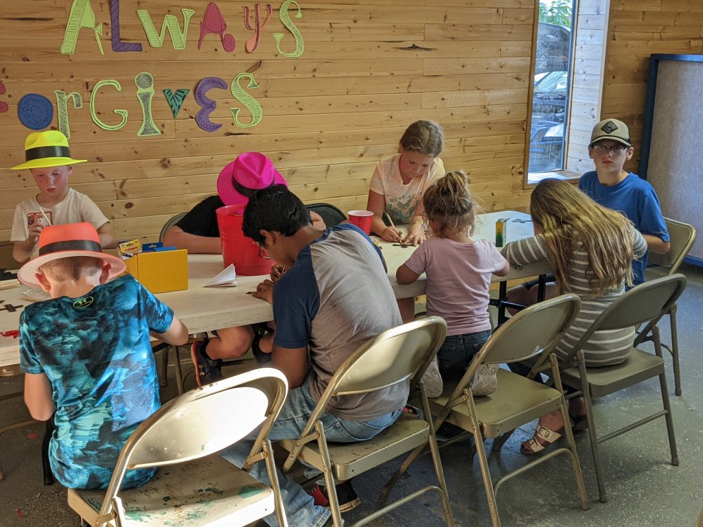 Kids coloring at a table together.